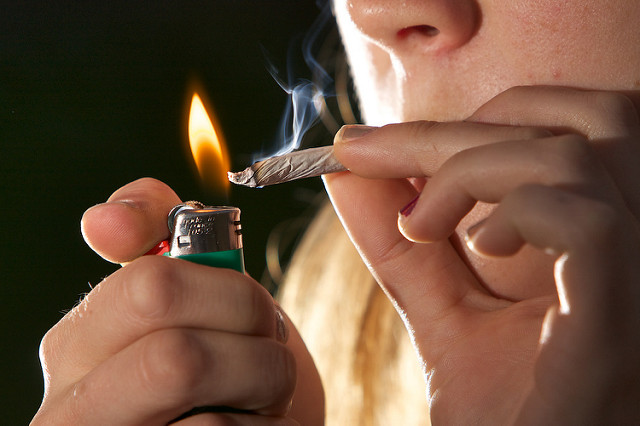 Marijuana DUI Laws in Arizona - person lighting a marijuana cigarette
