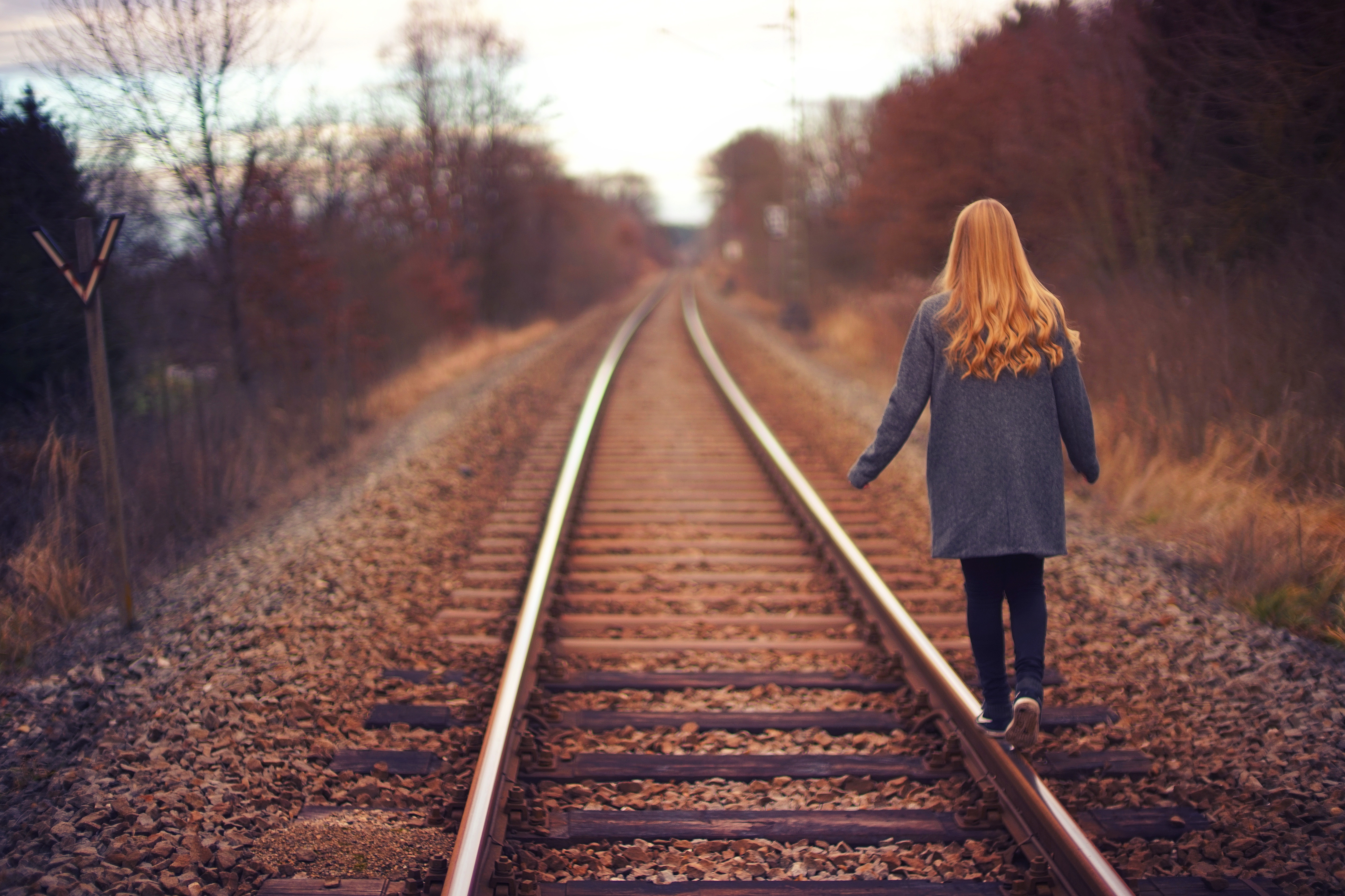 sexual abuse in Phoenix, Arizona - back of a youngster walking on railroad tracks