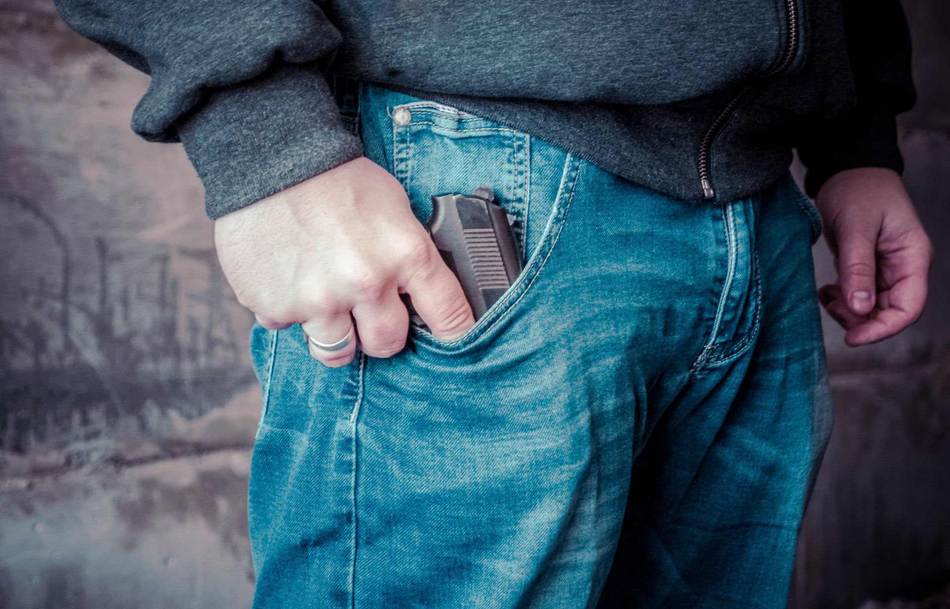 defensive display of a firearm - person showing gun in pocket