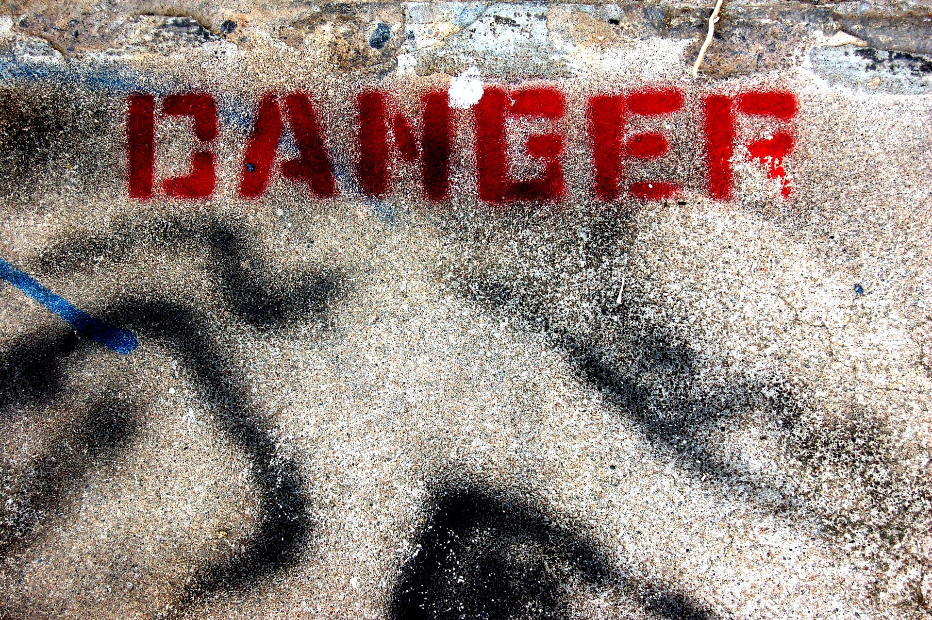 dangerous offense crime - word danger spray painted in red on concrete