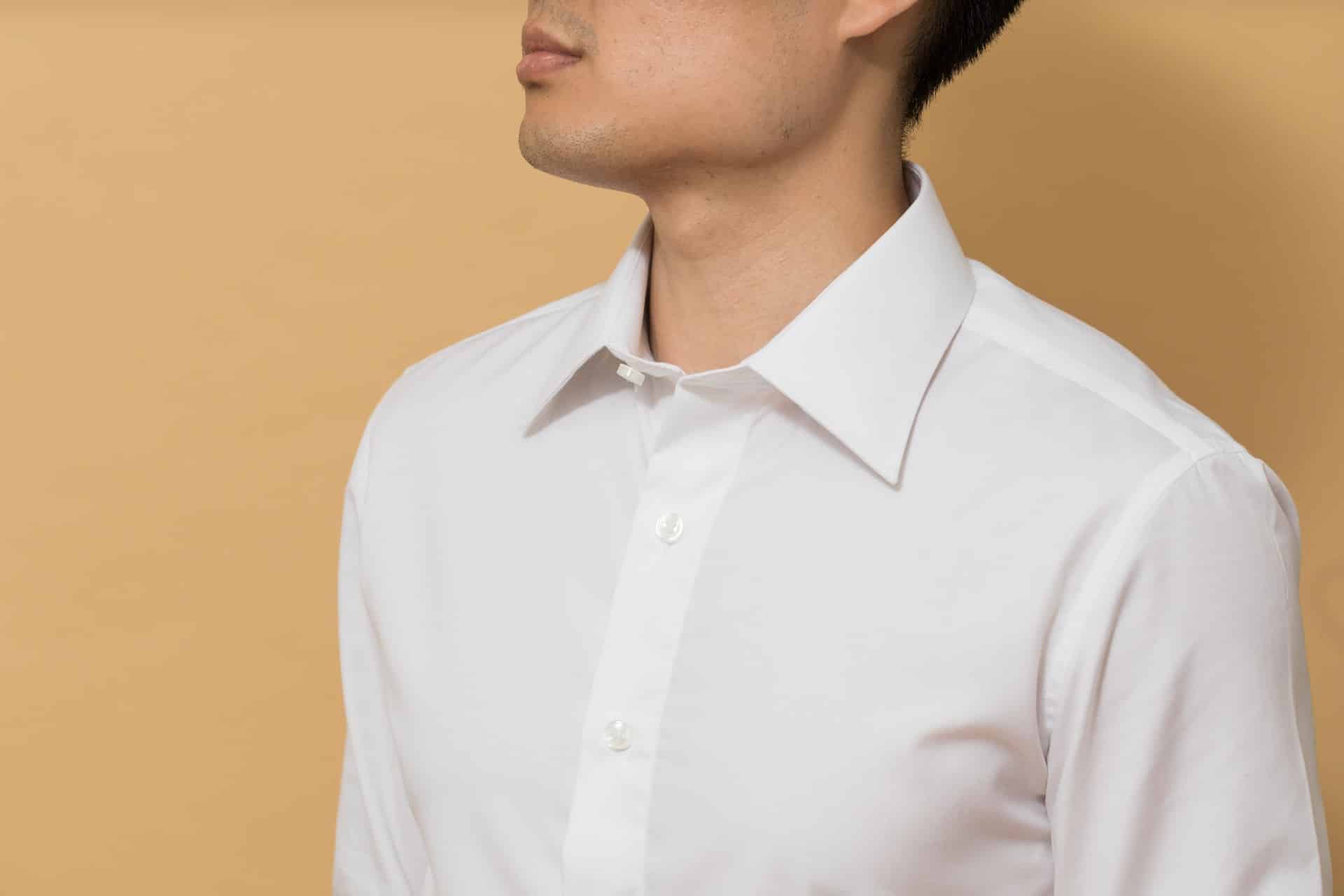Images of a man in a white collared shirt against orange background - What are white collar crimes