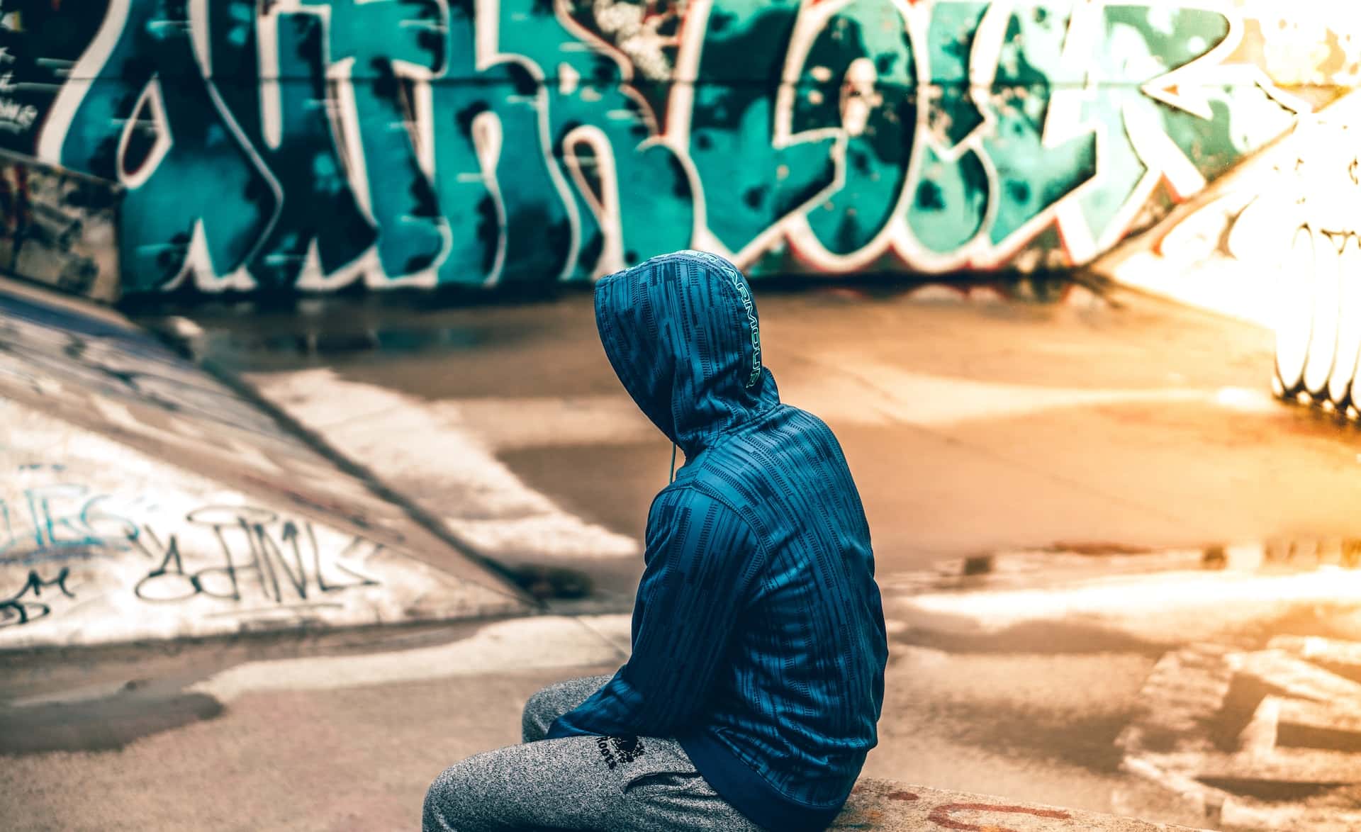 teen sitting in front of graffiti -cases for juvenile court
