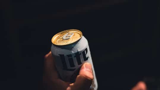 person holding a beer can - throwing a drink at someone is assault