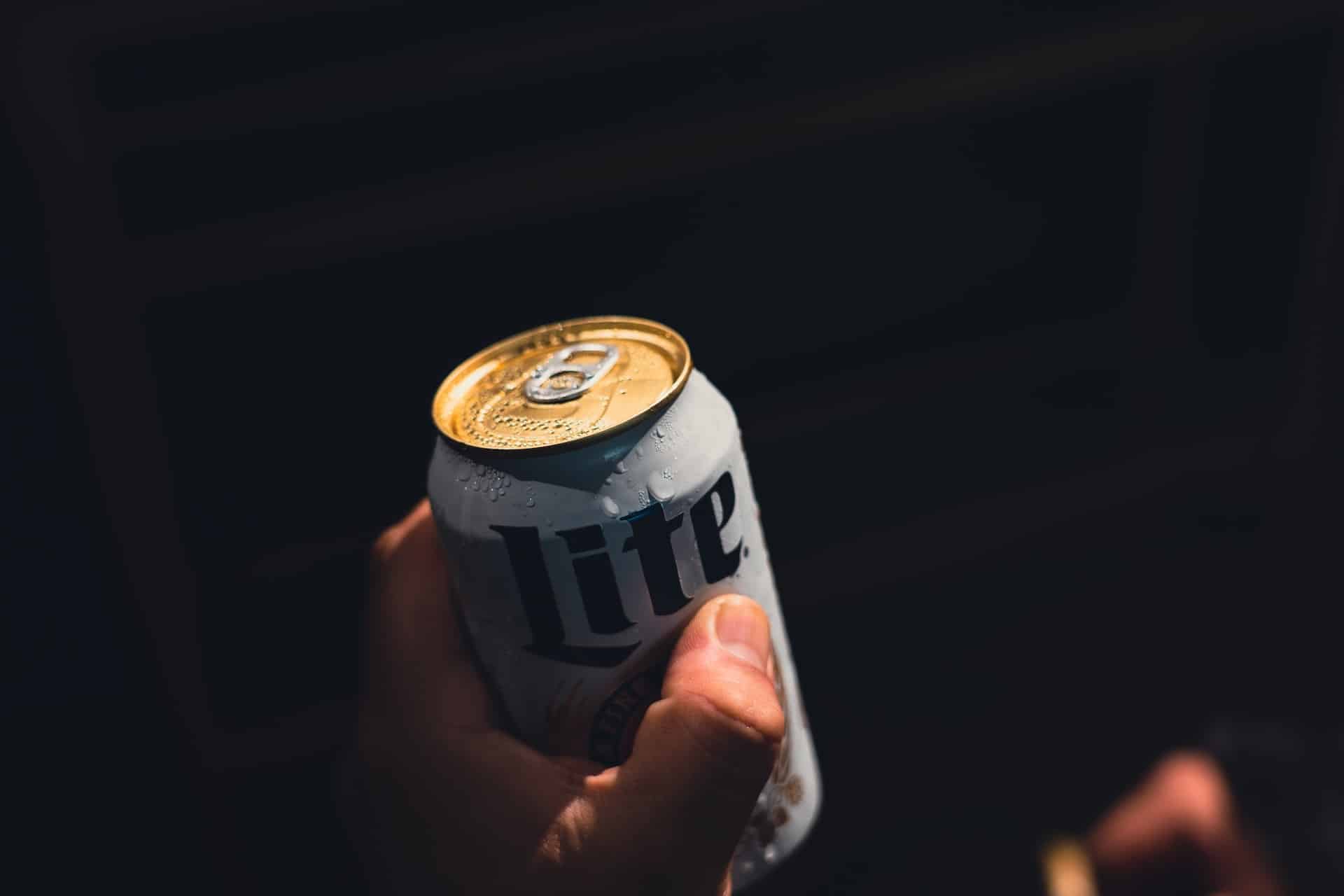 person holding a beer can - throwing a drink at someone is assault