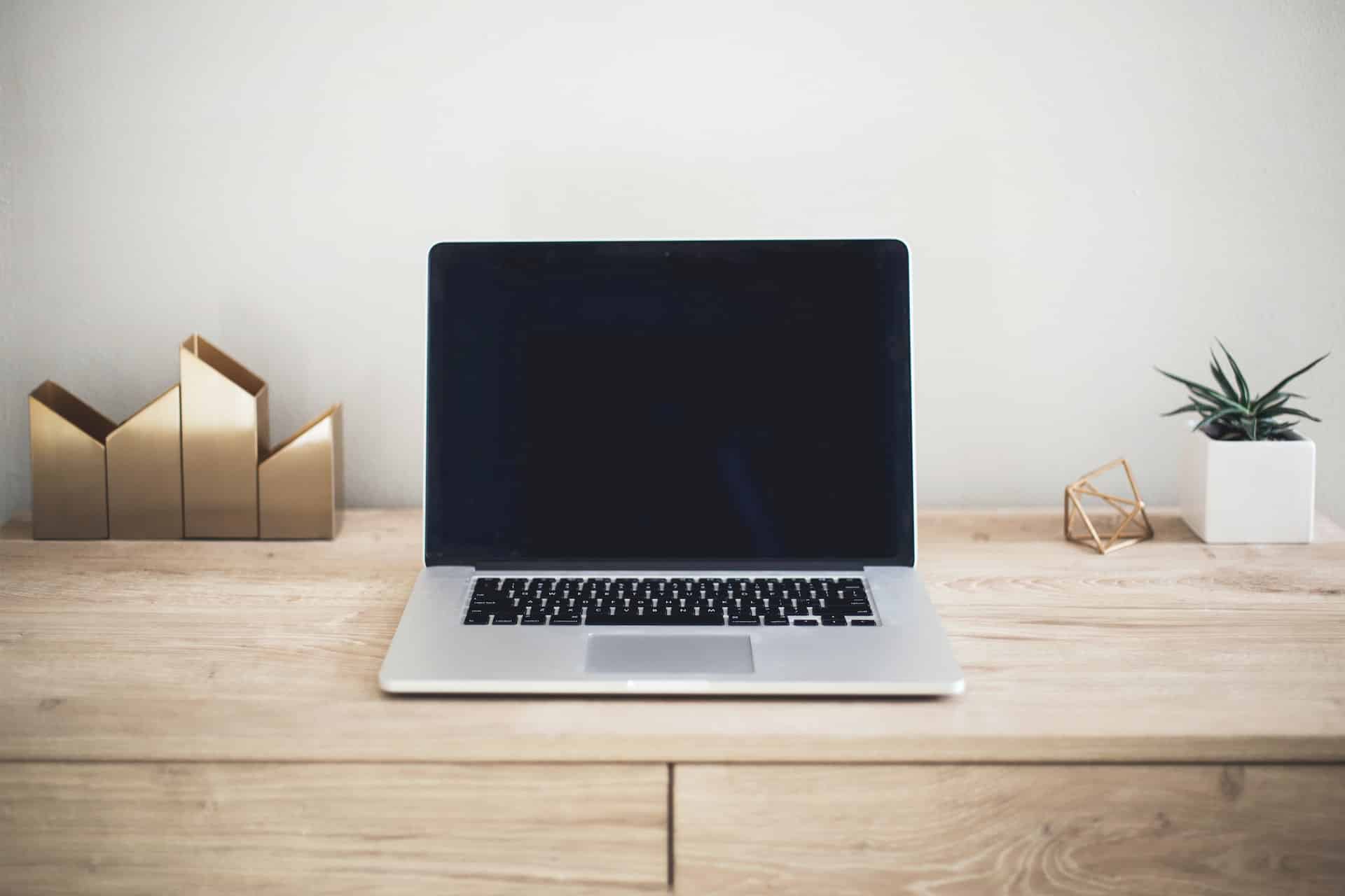 laptop on top of a wood desk - computer tampering