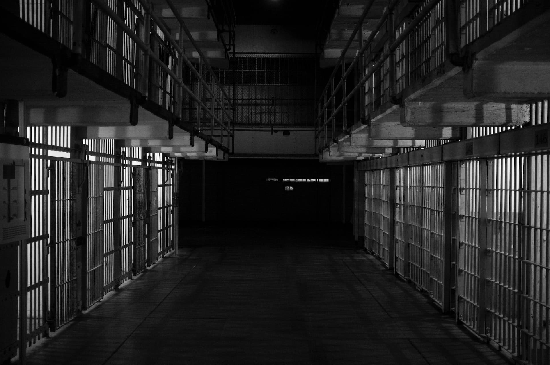jail vs prison, cells in a dark corridor