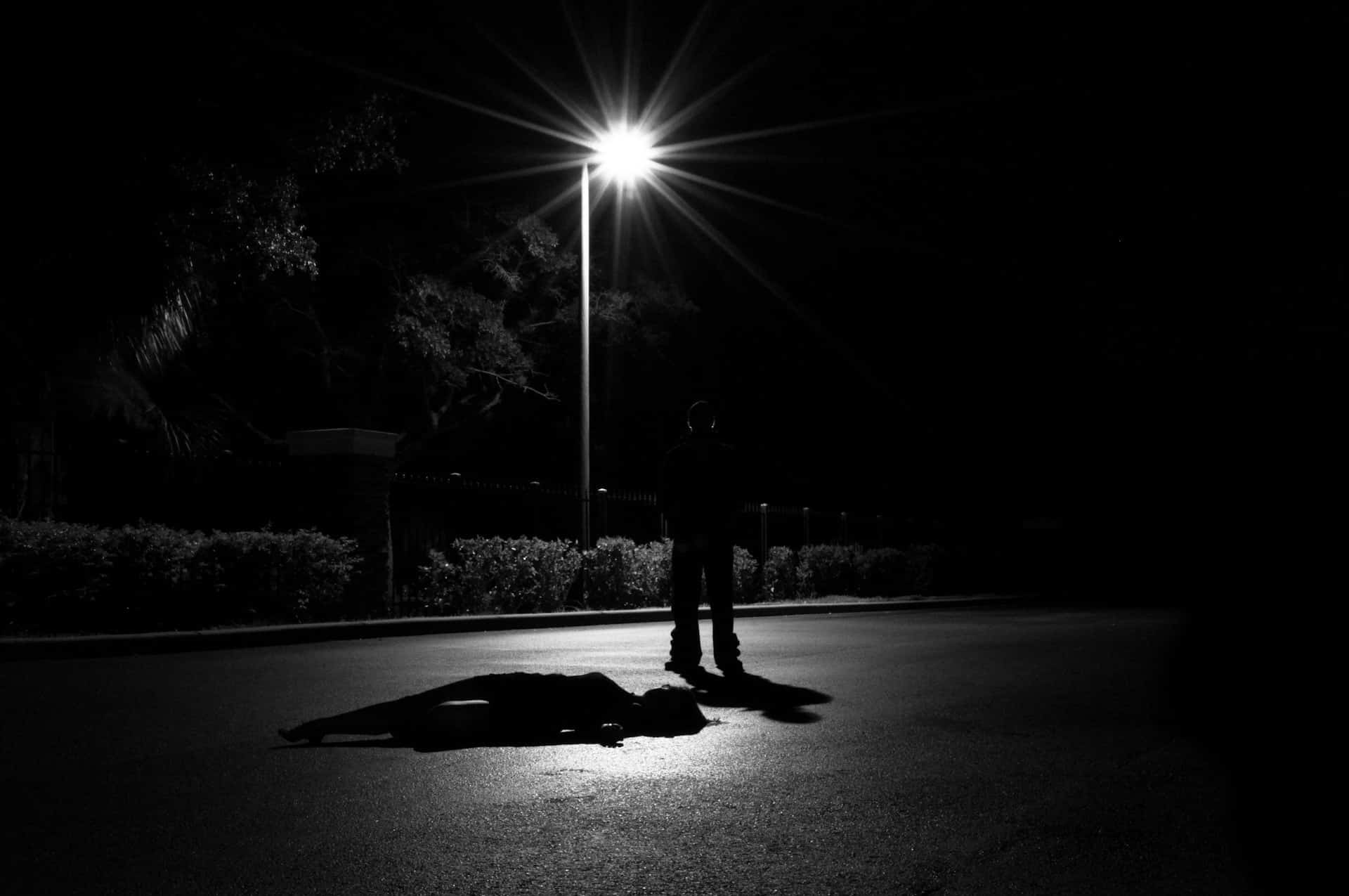 shadow of a man under a street light -definition of hate crime in Arizona