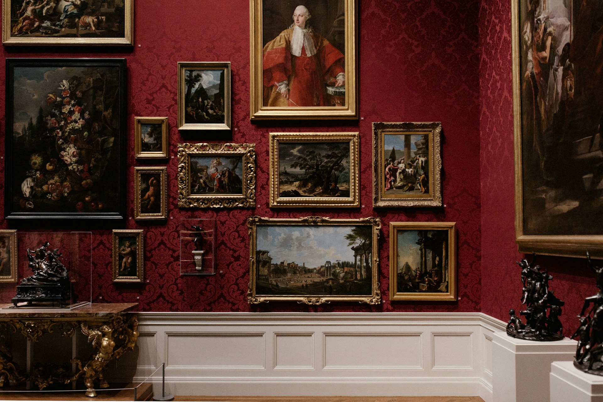 classic art on a red wall -is art theft different from regular theft