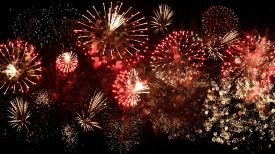 fireworks going off in a dark sky