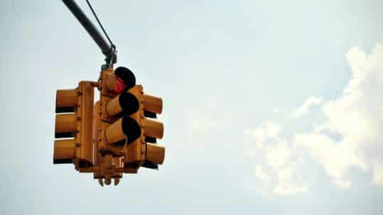 blue sky, with yellow traffic light and red light